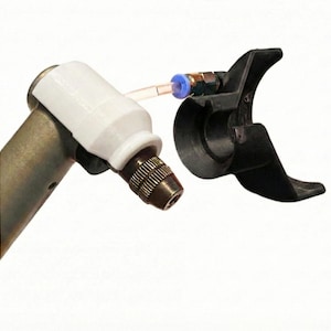 May include: A metal and white tool with a black attachment. The tool has a white cylindrical piece attached to the metal body. A clear tube and blue fitting connect to a black, curved piece.