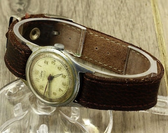 Reloj de pulsera Optima resistente a golpes, fabricado en Suiza, estilo militar, años 50, calibre ETA 1080, un caso excepcional.