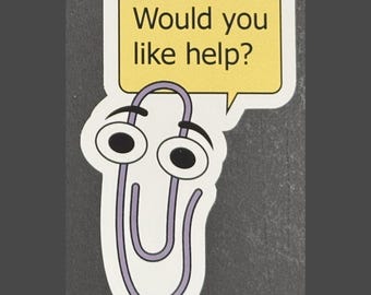 May include: A purple paperclip with googly eyes and a speech bubble that says "Would you like help?"