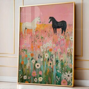 May include: A framed art print depicting two horses in a field of wildflowers. One horse is white, the other is black. The background is a blend of pink, yellow, and orange hues, with a gold frame.