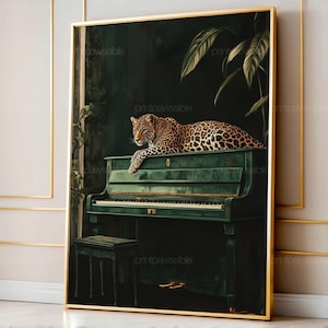 May include: A framed art print featuring a leopard resting on a green piano. The artwork has a dark, moody aesthetic with lush greenery and a gold frame. The leopard's spotted coat contrasts with the piano's color.
