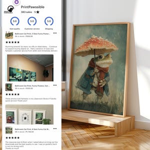 May include: A framed art print featuring a frog dressed in a coat and scarf, holding an umbrella. The frog is standing in the rain under a mushroom-shaped umbrella. The artwork is displayed on a wooden shelf.