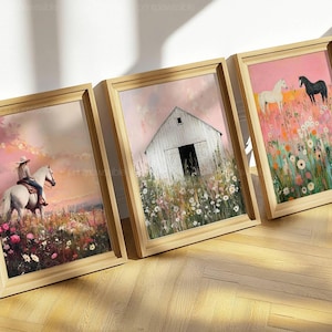 May include: Three framed art prints with a rustic theme. One print shows a person riding a white horse in a field of flowers. Another depicts a white barn in a field. The third print shows two horses in a field of flowers.
