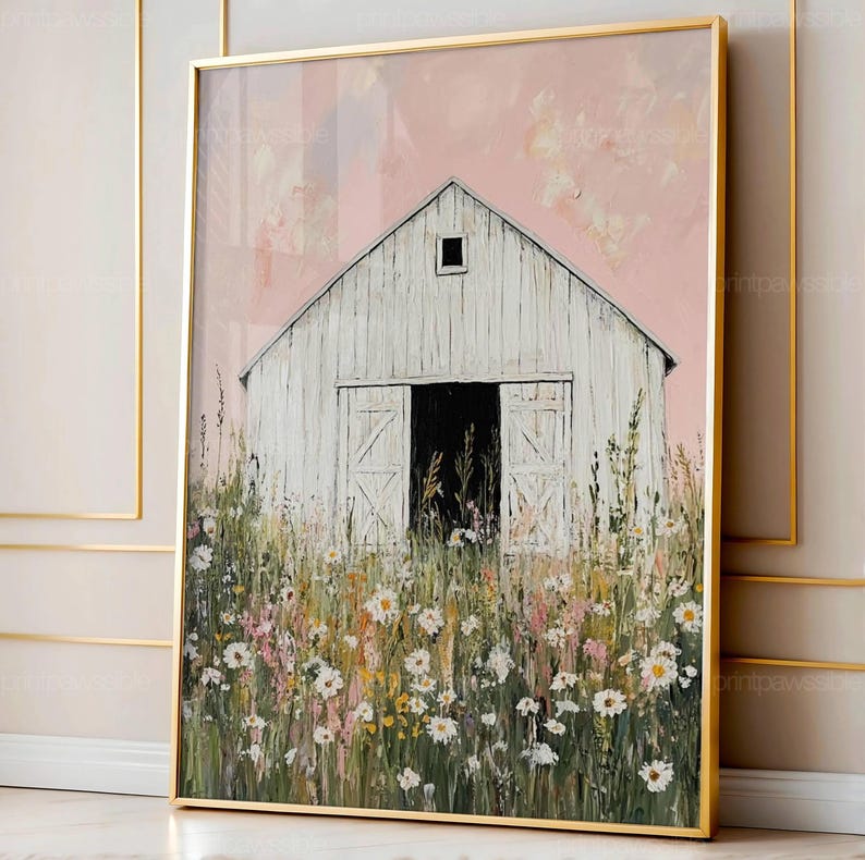 May include: A framed painting depicting a white barn with open doors, set against a pink sky. The barn is surrounded by a field of wildflowers in white, yellow, and pink. The artwork is enclosed in a gold frame.