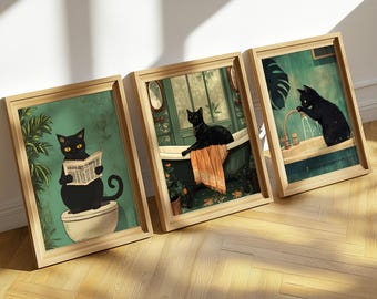 May include: Three framed prints featuring black cats in various bathroom settings. One cat is reading a newspaper while sitting on a toilet, another is taking a bath, and the third is drinking from a faucet.