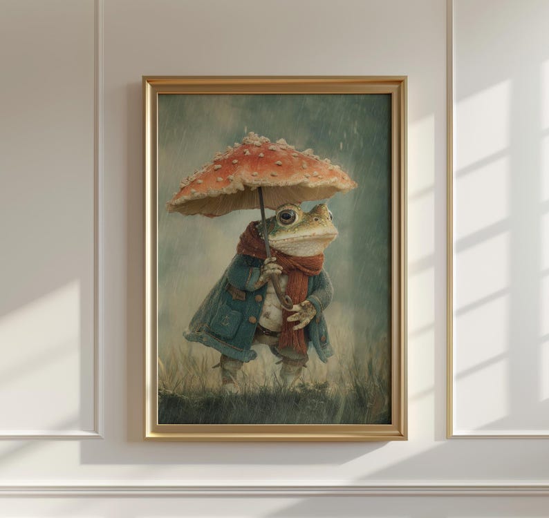 May include: A framed art print featuring a whimsical frog character. The frog is dressed in a blue coat and red scarf, holding a mushroom umbrella. The artwork has a vintage, storybook aesthetic, with a muted color palette and a rainy background.