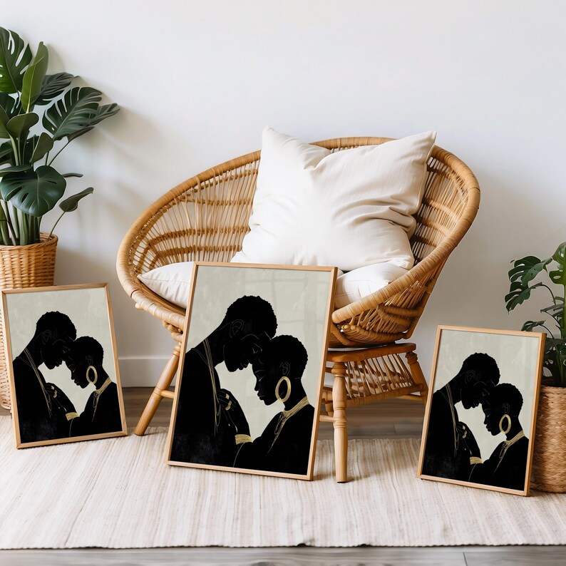 May include: Four framed art prints featuring black silhouettes of a couple embracing. The artwork has a neutral color palette with a beige background and wooden frames. The prints are displayed near a wicker chair and potted plants.