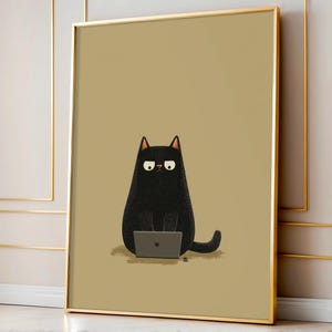 May include: Framed art print featuring a cartoon black cat sitting and working on a laptop. The cat has a grumpy expression and is set against a tan background. The artwork is enclosed in a gold frame.