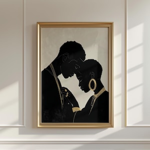May include: A framed art print featuring a black and gold illustration of two figures in an embrace. The figures are in silhouette, with gold jewelry accents. The artwork is set against a neutral background, and framed in a gold tone.