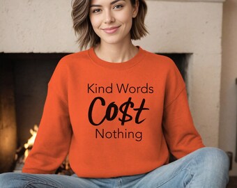 May include: Orange sweatshirt with the text "Kind Words Cost Nothing" in black.