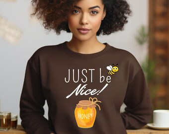 May include: Brown sweatshirt with a white graphic of a honey jar and a bee with the text "Just be Nice!"