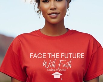 May include: A red t-shirt with the text "FACE THE FUTURE With Faith Class of 2024" in white. The shirt features a graduation cap graphic. The person is wearing the shirt outdoors with a mountain backdrop.