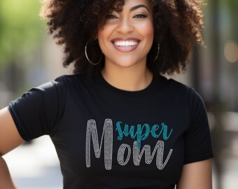 May include: A black t-shirt with the words "super mom" in teal rhinestones.