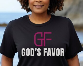 May include: A black t-shirt with a pink "GF" logo and the text "GOD'S FAVOR" in white.