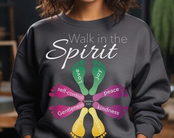 May include: A grey sweatshirt with the text "Walk in the Spirit" and a graphic of footprints in a circle. The footprints are in different colours and have words like "love", "joy", "peace", "kindness", and "gentleness" written on them.