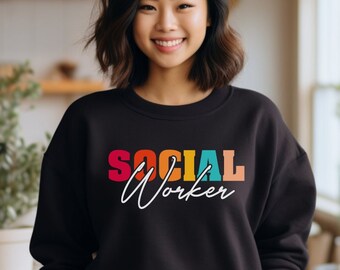 May include: A black sweatshirt with a colourful graphic that says "SOCIAL WORKER" in rainbow colours.