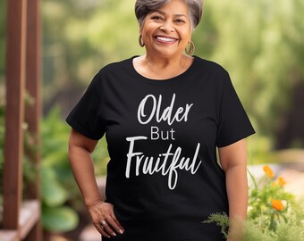 May include: A black t-shirt with the text "Older But Fruitful" in white lettering.