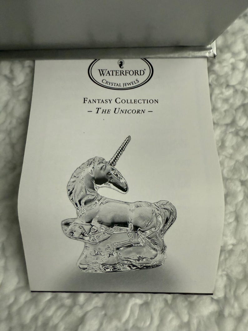 May include: Waterford Crystal Jewels Fantasy Collection - The Unicorn - A crystal figurine of a unicorn standing on a rock.