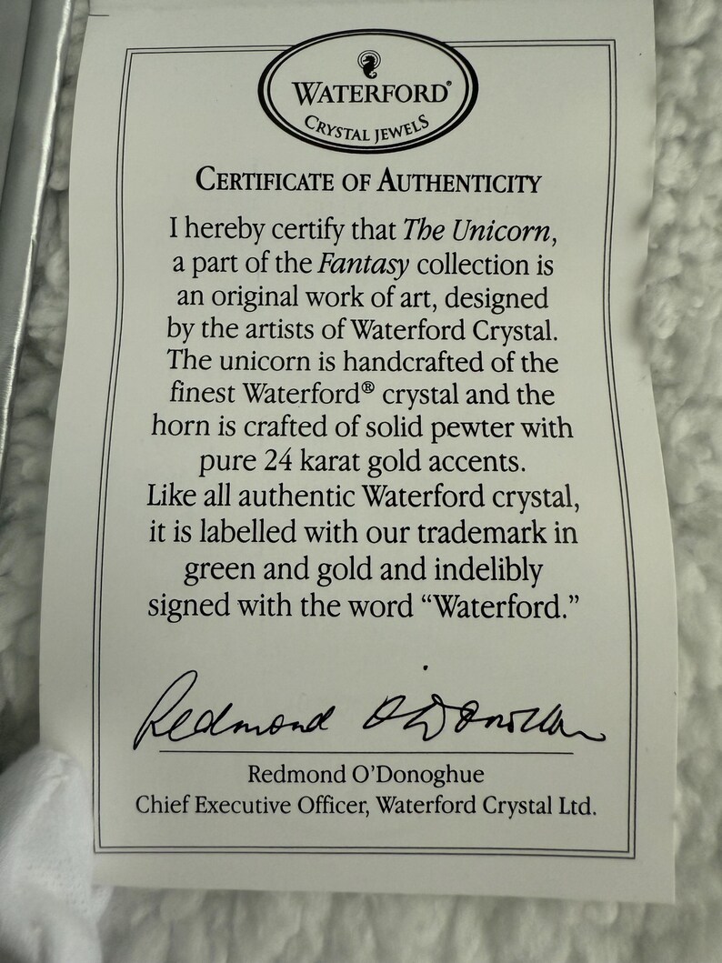 May include: A white certificate of authenticity for The Unicorn, part of the Fantasy collection, designed by the artists of Waterford Crystal. The certificate is signed by Redmond O'Donoghue, Chief Executive Officer, Waterford Crystal Ltd.
