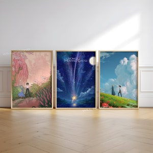 May include: Three framed posters featuring scenes from the animated film Howl's Moving Castle. The first poster shows a pink and blue scene with a castle in the background. The second poster shows a night sky with a shooting star and the text "Howl's Moving Castle". The third poster shows a green field with a couple walking towards a blue sky with clouds.