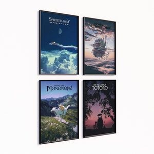 May include: Four framed art prints featuring scenes from animated films. The prints include "Spirited Away," "Howl's Moving Castle," "Princess Mononoke," and "My Neighbor Totoro." Each print has a black frame and is displayed against a white wall.