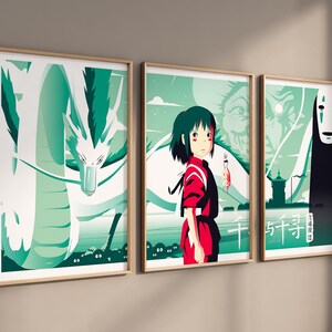 May include: A set of three framed prints featuring characters and scenes from the animated film Spirited Away. The first print shows a white dragon with green scales, the second print shows a young girl with red hair and a white spirit, and the third print shows a black spirit with a white mask.