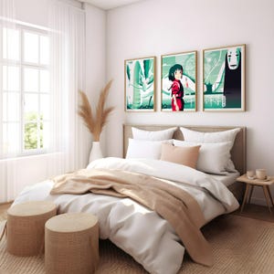 May include: A white bed with a beige blanket and two beige woven stools. The bed has a white headboard and a white and beige pillow. Three framed posters with anime characters and Japanese text hang on the wall behind the bed.