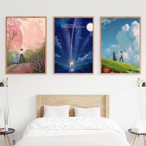 May include: Three framed posters with scenes from the animated film Howl's Moving Castle. The first poster shows a couple walking through a pink and green forest. The second poster shows a blue night sky with a shooting star and the words "Howl's Moving Castle". The third poster shows a couple walking on a green hill with a blue sky and white clouds.