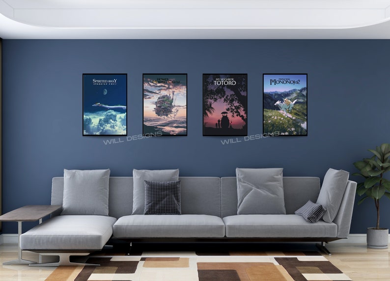 May include: Four framed movie posters hang on a blue wall above a gray sectional sofa. The posters feature artwork from animated films, including "Spirited Away," "Howl's Moving Castle," "My Neighbor Totoro," and "Princess Mononoke."