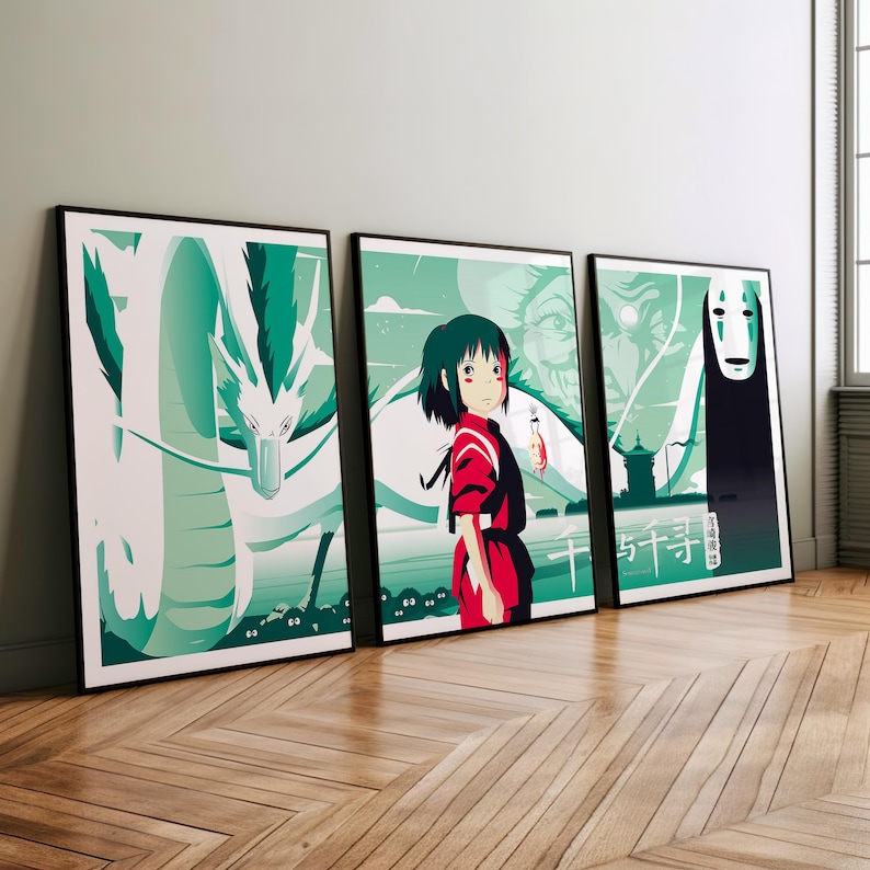 May include: Three framed prints of a Japanese animated film. The first print features a white dragon with green and blue accents. The second print features a young girl with red hair and a red and white outfit. The third print features a black and white figure with a white mask. The text "千と千尋の神隠し" is visible on the third print.