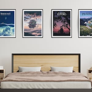 May include: Four framed movie posters featuring Japanese animated films. The posters are displayed above a bed with a wooden headboard. The posters include "Spirited Away," "Howl's Moving Castle," "My Neighbor Totoro," and "Princess Mononoke."