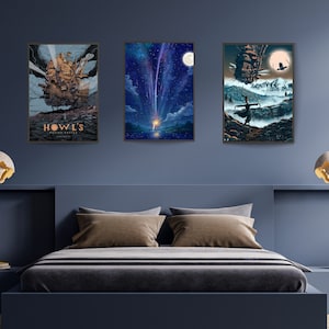 May include: Three framed posters featuring scenes from the animated film Howl's Moving Castle. The first poster shows the moving castle against a blue sky with the title "Howl's Moving Castle" in gold lettering. The second poster shows a young woman standing in a field with a shooting star in the sky. The third poster shows the moving castle in the distance with a young woman standing in the foreground.