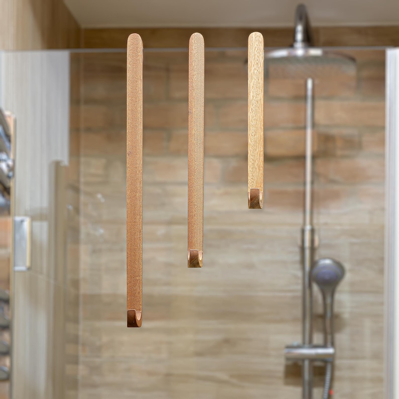 A set of three walnut wood hooks for shower cabin. Perfect for small bathrooms! Simply place it over the glass wall. Easy and comfortable to use.