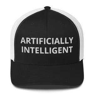 May include: Black and white trucker hat with the words "ARTIFICIALLY INTELLIGENT" in bold, white capital letters across the front. The hat has a black front panel and a white mesh back.