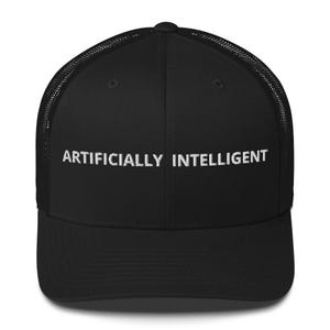 May include: Black trucker hat with the white text "ARTIFICIALLY INTELLIGENT" embroidered across the front. The hat has a mesh back and a curved brim. The hat is a classic style.