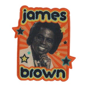May include: An orange and yellow patch with a picture of James Brown in a white suit. The patch has a starburst design and the text "james brown" in black.