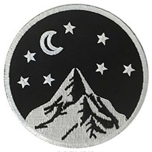May include: A black and white embroidered patch with a mountain range, a crescent moon, and stars against a black background.