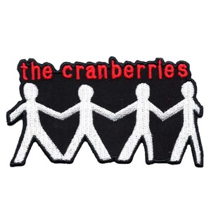 May include: Embroidered patch featuring the band name "the cranberries" in red lettering above a row of four white stick figures holding hands against a black background. The patch has a white border.