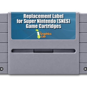 May include: A gray plastic Super Nintendo game cartridge featuring a blue rectangular label. The label displays the white text Replacement Label for Super Nintendo (SNES) Game Cartridges and a logo for The Graphics Lab with a green test tube.