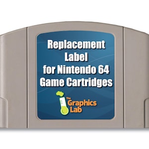 May include: A gray Nintendo 64 game cartridge featuring a blue rectangular label with white text that reads Replacement Label for Nintendo 64 Game Cartridges and a logo for The Graphics Lab with a green bubbling test tube icon.