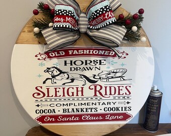 Old fashion sleigh rides wooden round sign