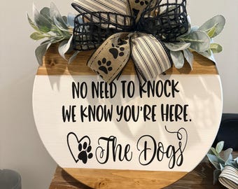 No need to knock we know your here the dogs wooden round sign