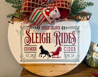 Old fashion sleigh rides wooden round sign