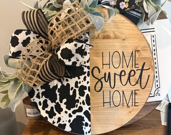 Home sweet home with cow print wooden round sign