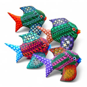 May include: Five colourful wooden fish ornaments with intricate geometric patterns. The fish are painted in shades of red, orange, green, blue, and purple.
