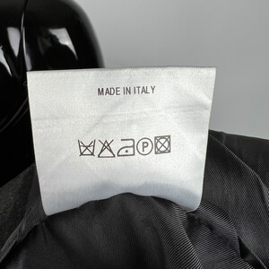May include: White care label with black text "MADE IN ITALY" and black care symbols for washing, bleaching, ironing, and dry cleaning.