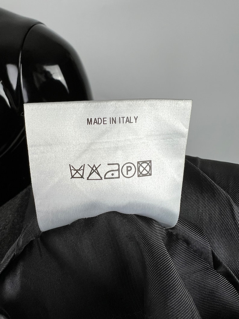 May include: White care label with black text "MADE IN ITALY" and black care symbols for washing, bleaching, ironing, and dry cleaning.