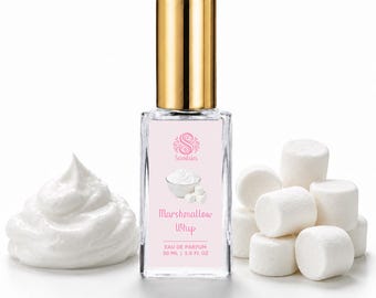 May include: A rectangular glass perfume bottle with a gold cap and a light pink label featuring the text Scentsics, Marshmallow Whip, and 30 ml | 1.0 fl oz. The bottle is flanked by a swirl of white cream and several white marshmallows.