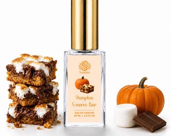 May include: A clear glass perfume bottle with a gold cap and a label reading Scenties Pumpkin S'mores Bar Eau de Parfum 30 ml 1.0 fl oz, flanked by a stack of three s'mores bars, a whole orange pumpkin, a white marshmallow, and a chocolate square.