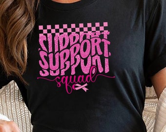 May include: Black t-shirt with a pink graphic that says "Support Squad" with a pink ribbon underneath.